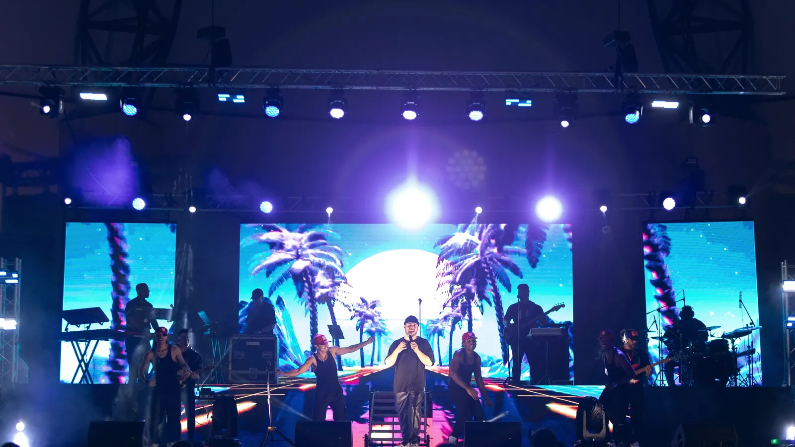 Live worship performance with a wide center LED wall and two side screens